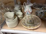 many plates and bowls on a shelf in a room