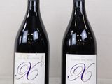 two bottles of wine sitting next to each other on a table