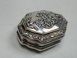 a silver box that has a design on it