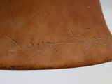 a bell with writing on it on a white surface