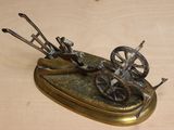 a statue of a man on a cart with a horse and buggy