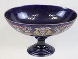 a blue bowl with a dragon design on it