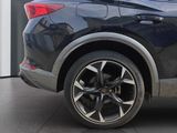 a close up of a black car parked in front of a building