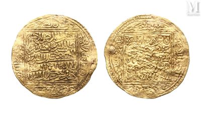 a close up of two gold coins with arabic writing on them