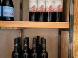 many bottles of wine sitting on a shelf in a room