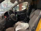 the interior of a car with the door open and the driver ' s seat down