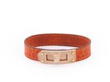 a brown leather bracelet with a gold clasp