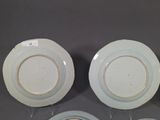 two white plates with gold rims are sitting on a table