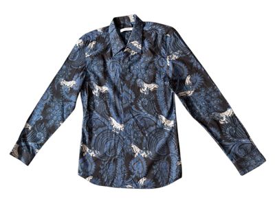 the shirt is long sleeved and has a pattern of horses on it