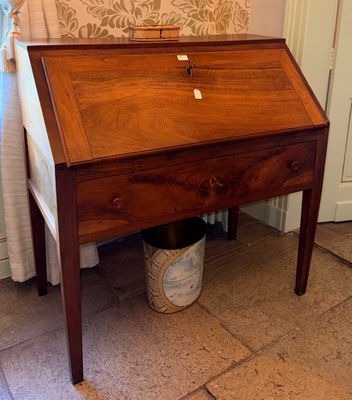 a small wooden desk with a drawer underneath it