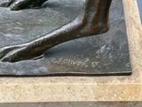 a bronze statue of a person ' s foot on a stone block