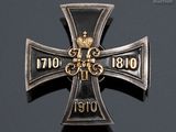 an iron cross with a crown on it sitting on top of a table