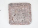 a small square shaped object on a white surface