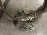 a statue of a fish on the floor of a building
