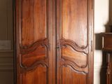 a large wooden cabinet in the corner of a room