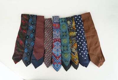 several different colored ties are hanging on a white mannequin