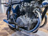 a blue motorcycle that is on display in a museum