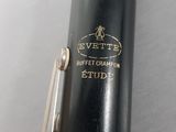 an image of a close up of a clarinet with a silver and black case