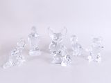 five crystal figurines of mice on a white surface