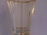 a clear glass vase with a green design on it