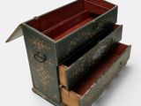 a small chest with two drawers in it on a white surface