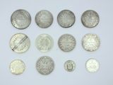 a close up of a bunch of coins on a white surface