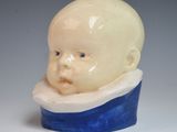 porcelain figurine of a baby in a blue and white bowl