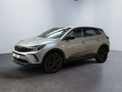 a silver suv parked in a room with a black floor