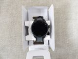 a black and white watch sitting in a white box