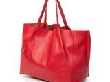 a red leather tote bag on a white background