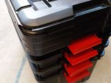 a black plastic box with two red boxes in it