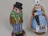 two figurines of a clown and a clown in a top hat