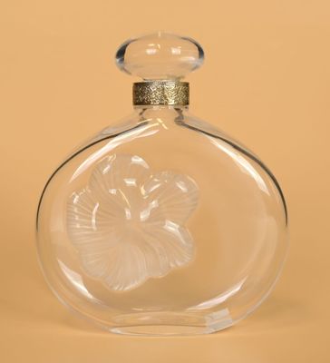 a clear glass bottle with a flower inside of it