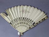 a white fan that is hanging on the wall