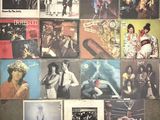 many different album covers on the wall of a room