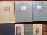 several old books are lined up on a table