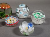 five glass marbles that are sitting on a table