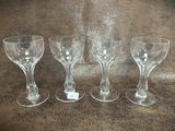 three wine glasses sitting on a table next to each other