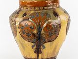 un vase jaune orné d'un arbre sur fond blanc