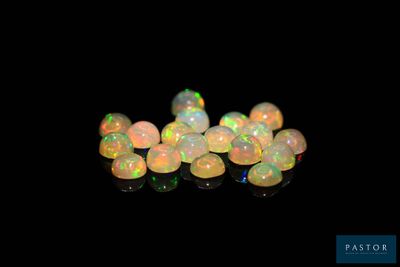 a group of white oplites sitting on top of a black surface