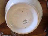 a white bowl sitting on top of a wooden table
