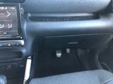 the interior of a car with a steering control and dashboard controls