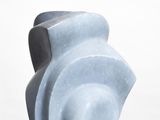 a blue sculpture on a white pedestal on a white surface
