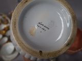 a close up of a vase with a tag on it