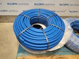 two blue hoses sitting on top of a pallet in front of a wall