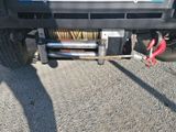 a truck with a winch attached to it ' s bumper