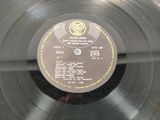 an old record with a label on it sitting on top of a table
