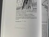 an open book with a drawing of a woman in a dress