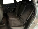 the back seats of a silver car with black seats in the back