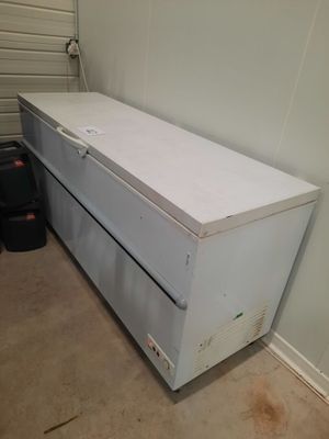 an image of a white chest of drawers in a garage
